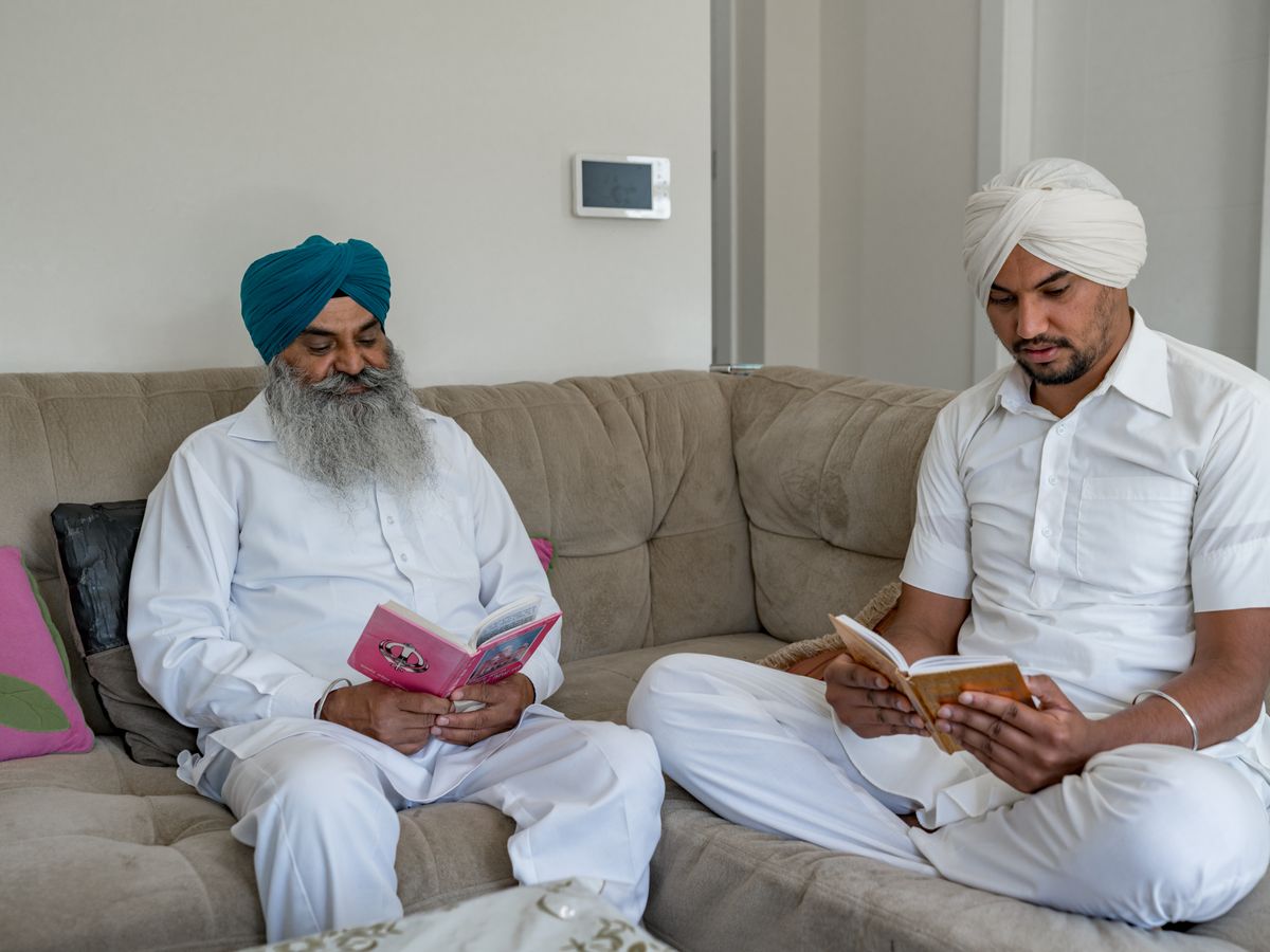 A father and son at home, going over the surgery estimate together